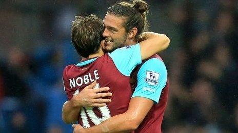 Mark Noble hugs Andy Carroll