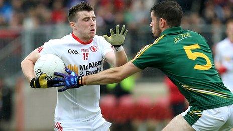 Tyrone's Conor McAliskey is tackled by Donal Keegan