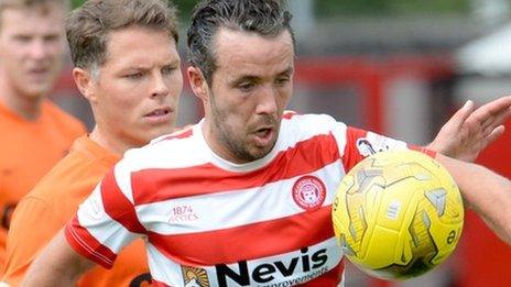 Dougie Imrie of Hamilton Academical is challenged by Dundee United's John Rankin