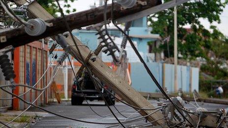 Power line poles downed by the passing of Hurricane Maria lie on a street in San Juan, Puerto Rico