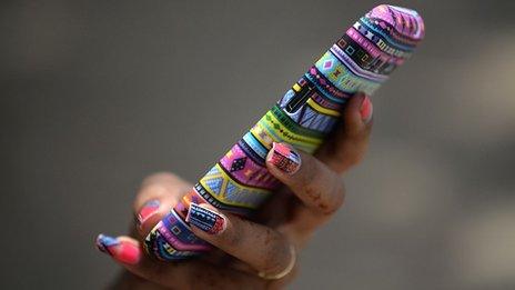 woman holding colourful smartphone