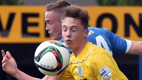 Andrew Burns of Dungannon Swifts competes against Ballymena's Matthew Shevlin