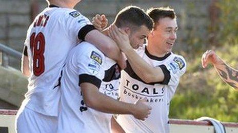 Crusaders players celebrate their opening goal at Shamrock Park