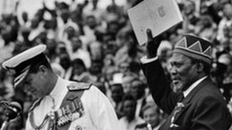 Jomo Kenyatta (right) holds official document of independence, December 1963