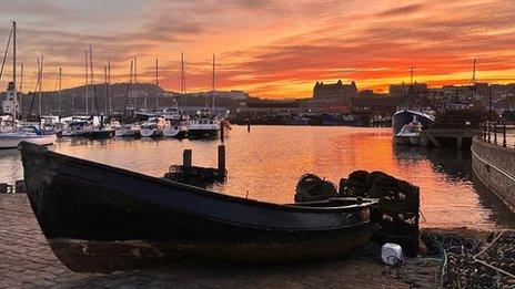 The sky is red and orange as the sun sets over Scarborough, North Yorkshire