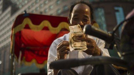 Man on bike counting money