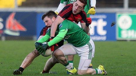 Fermanagh's Daniel Teague and Down opponent Sean Dornan tussle for the ball