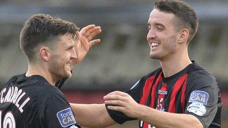 Diarmuid O'Carroll celebrates his goal with Crusaders team-mate Josh Robinson