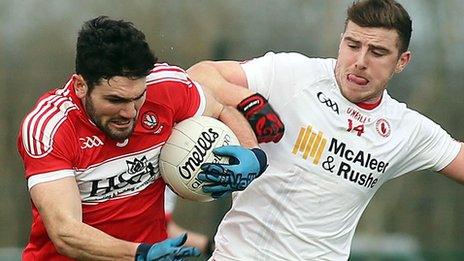 Derry's Danny Heavern is challenged by Tyrone forward Jonathan Munroe