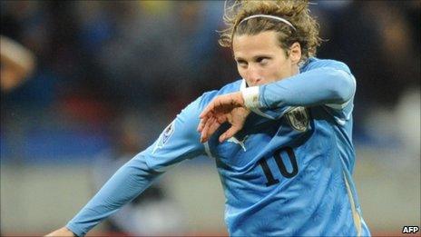 Diego Forlan celebrates after scoring in Uruguay 3-2 defeat by Germany for third place