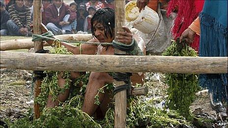 Alleged murderer Orlando Quishpe is punished by being bathed with cold water and flogged with stinging nettles by members of his community La Cocha, in Zumbahua, Ecuador.