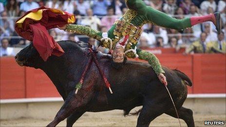 Spanish bullfighter Jose Tomas is tossed by a bull during a bullfight in Barcelona - 5 July 2009