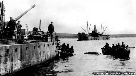 Crew of a German boat abandon ship in 1919 [Pic: Orkney Library and Archive]