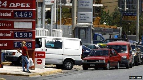 Cars line up outside a fuel station during a strike by truck drivers in Athens