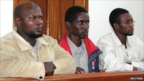 From left to right: Idris Magondu, Hussein Hassan Agad, and Mohamed Adan Abdow, stand in the dock at Nakawa Magistrates Court in Kampala