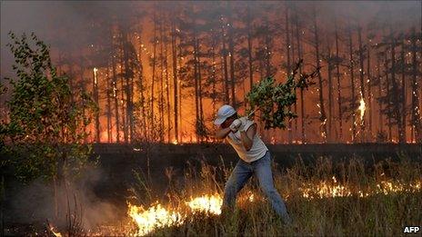 A man tries to stop fire near village of Dolginino in Ryazan region, about 100 miles southeast of Moscow, Russia, 4 August 2010