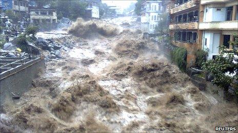 Floodwater tears through a town in north-west Pakistan (undated image from NGO Merlin)