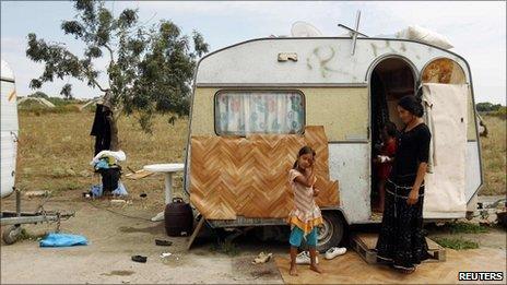 File photograph of a family in front of a caravan in an illegal Roma camp near Nantes, France