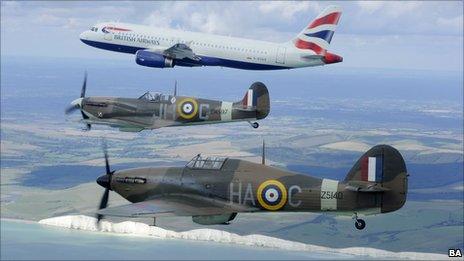 A Hurricane and Spitfire fly alongside an Airbus passenger jet as part of the Battle of Britain 70th anniversary celebrations