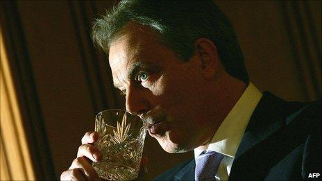 Tony Blair sipping from a tumbler