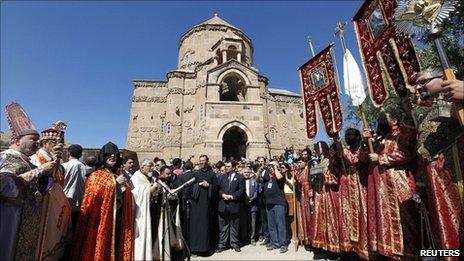 Priests and worshippers pray in front of the Church of the Holy Cross on Akdamar island