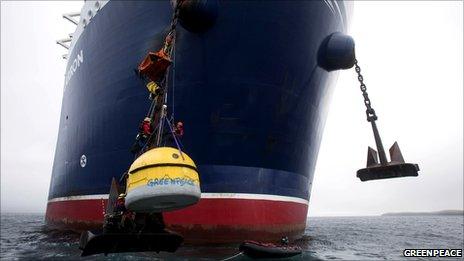 Greenpeace protesters attached to anchor