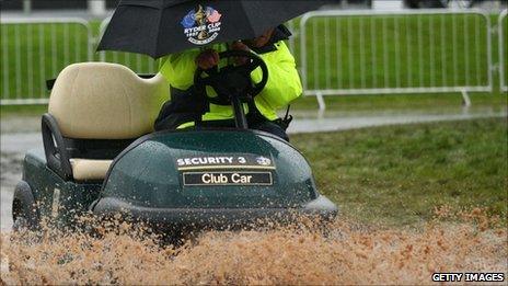 A golf cart negotiates the rain and mud at the Celtic Manor Resort on Sunday