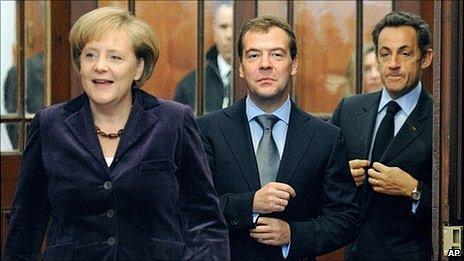 Angela Merkel, Dmitry Medvedev and Nicolas Sarkozy arrive for a meeting at their summit in Deauville, 19 October