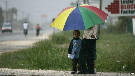 People shelter from the rain in Belize City (24 October 2010)