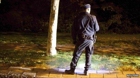 A police officer investigates a crime scene in Malmo, Sweden, October 20, 2010