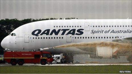 Qantas Airways 380 passenger plane flight QF32 is sprayed by rescue services after making an emergency landing at Changi airport in Singapore November 4, 2010