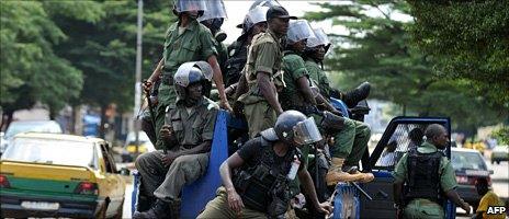 Policemen patrolling in a street following clashes in Conakry on 22 October 2010