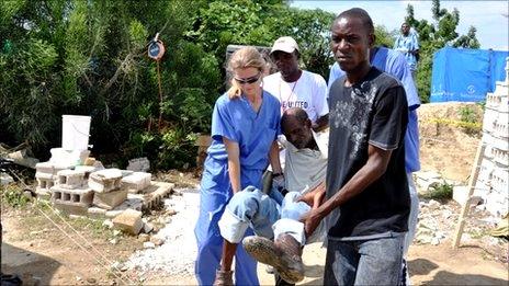 A patient is carried to the aid station at Cabaret, Haiti