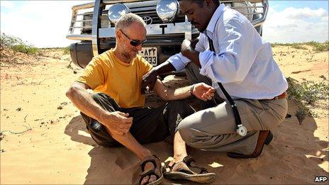 A photo made available on 28 January 2010 shows Briton Paul Chandler (left) being examined by Somali Doctor Abdi Mohamed Elmi Hangul (right) at a location in central Somalia