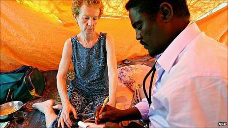 A photo made available on 28 January 2010 shows Briton Rachel Chandler (left) being examined by Somali doctor Abdi Mohamed Elmi Hangul (right) at a location in central Somalia