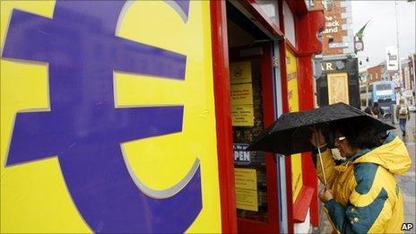 A woman enters a euro discount store in south Dublin, Ireland