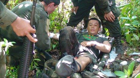 Rubiel Rodriguez being treated by his colleagues after stepping on a landmine on 2 May 2009