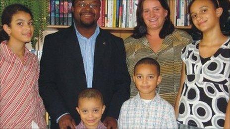 John Abraham Godson surrounded by his children and wife Aneta (image from his website)