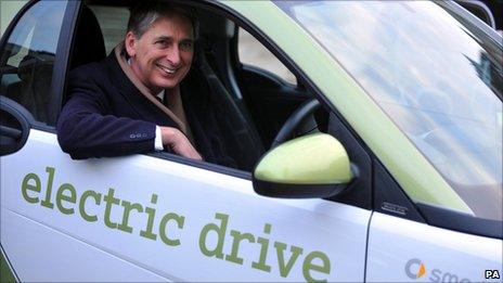 Transport Secretary Philip Hammond sits in a Smart fortwo electric car during the announcement that nine plug-in cars will be eligible for subsidies