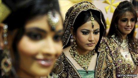 Indian models display bridal wear during a bridal make-up workshop in Amritsar, August 2010