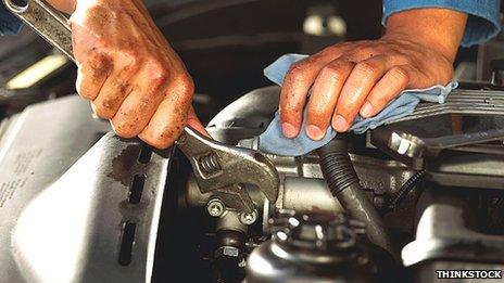 Person mending a car