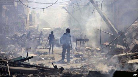 People walk down a street amid rubble in Port-au-Prince, in the immediate aftermath of the January 2010 earthquake.