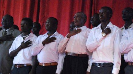 Singers singing the national anthem at the music X-factor competition