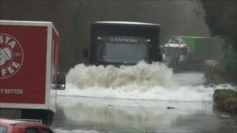 Vehicles stranded in flood water on the A487 near Machynlleth on Thursday