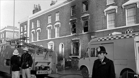 Emergency services and a policeman outside the scene of the New Cross fire in 1981