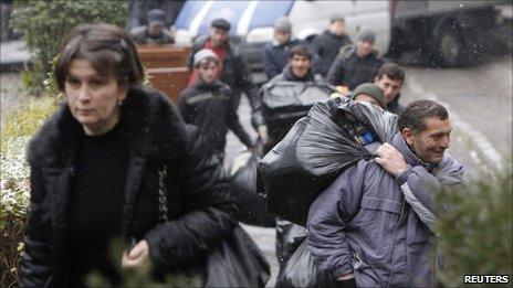 Evicted refugees leave their shelter in Tbilisi, 20 January