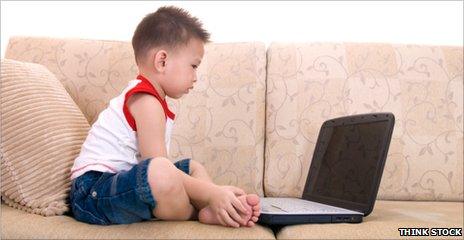 Toddler looking at a laptop