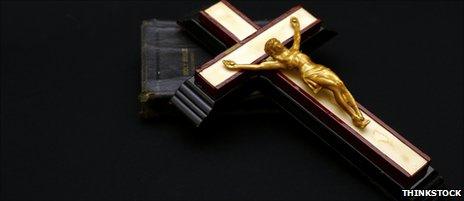 Gold crucifix resting on bible