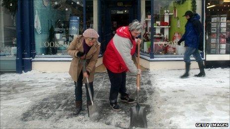 Shopkeepers clear snow in Wells on 20 December