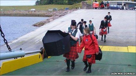 Members of a pipe band board the ferry after the opening ceremony. Image: Iain MacDonald/BBC